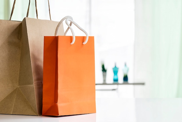 Paper shopping bags on white table