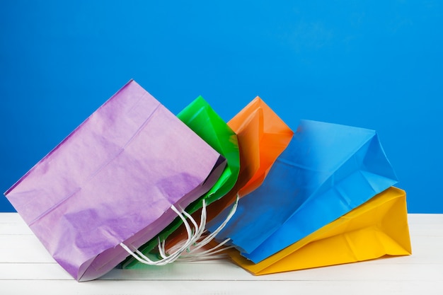 Paper shopping bags with copy space on blue background