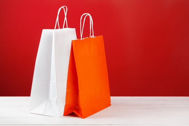 Paper shopping bags with copy space on red background