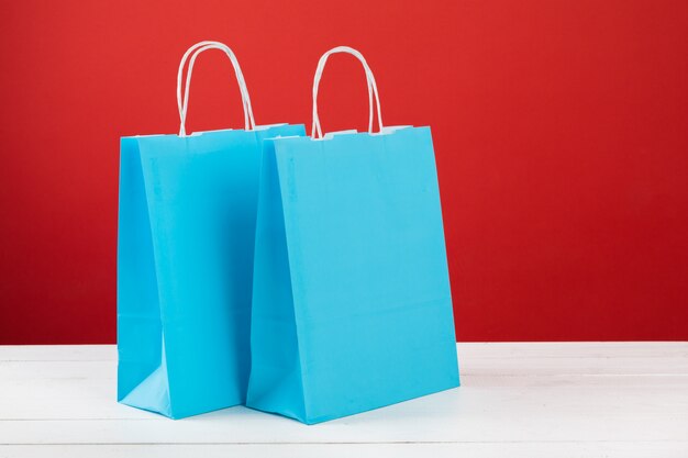 Paper shopping bags with copyspace on red 