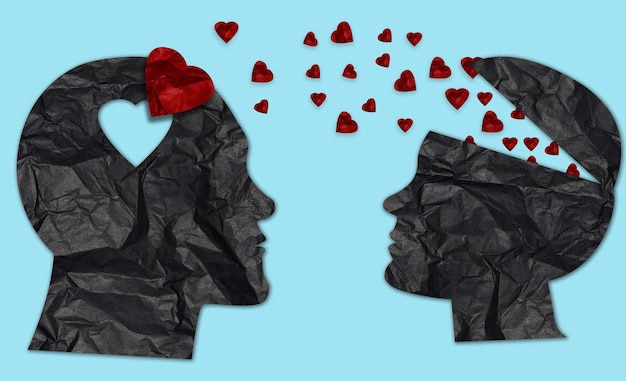 Paper silhouettes of man and woman from crumpled black paper and red hearts love concept