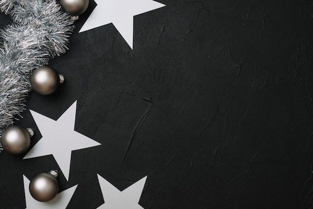 Photo paper stars with baubles on table