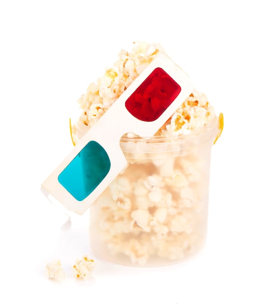 Paper striped bucket with popcorn and 3D glasses isolated on white background with clipping path.