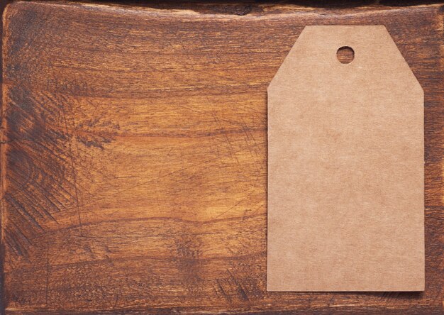 Paper tag price at aged wooden background texture surface