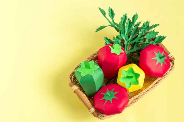 Paper tomatoes peppers and parsley in wicker tray