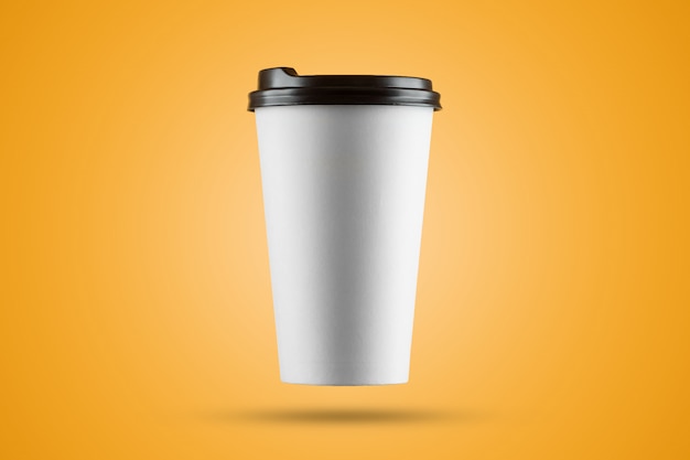 Paper white coffee cup isolated on a yellow background