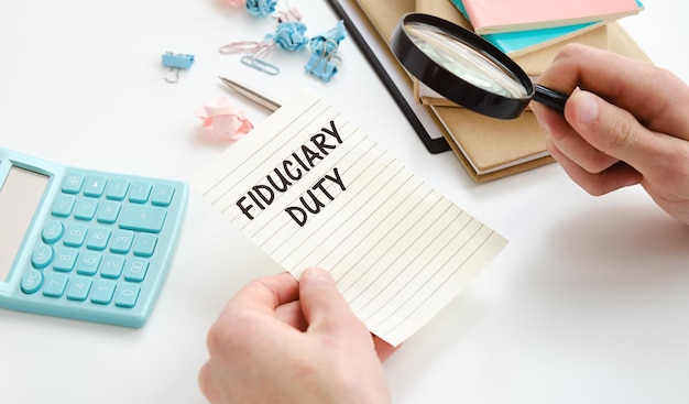 Photo paper with fiduciary duty in hand on a table