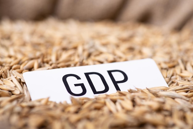 Paper with inscription GDP on oat grain