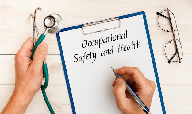 Paper with Occupational Safety and Health on the office desk, stethoscope