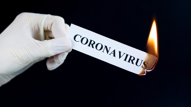 Paper with the text Coronavirus is burning in the hand. Coronavirus pandemic end concept. The virus has been defeated.