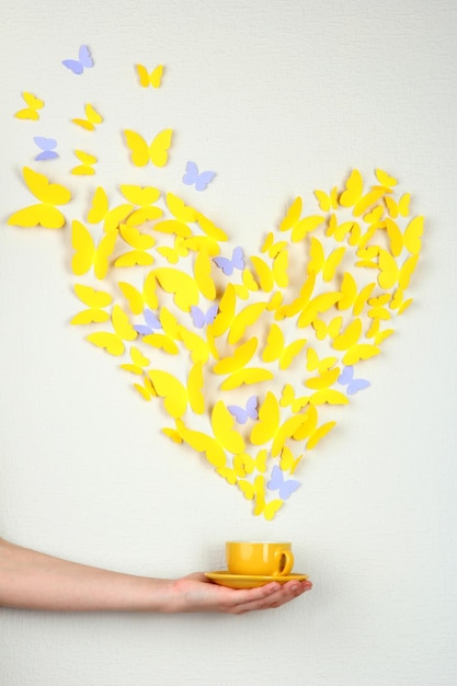 Paper yellow butterfly in form of heart fly out cup