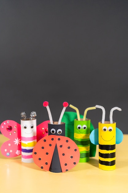 Papercraft project. Colorful bugs made out of empty toilet rolls.