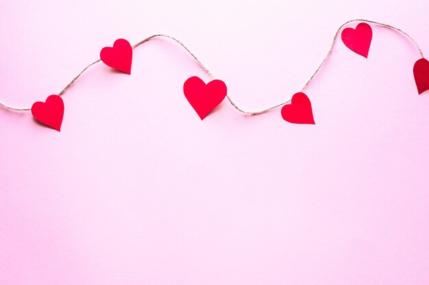 Papier harten op een roze achtergrond Valentijnsdag concept