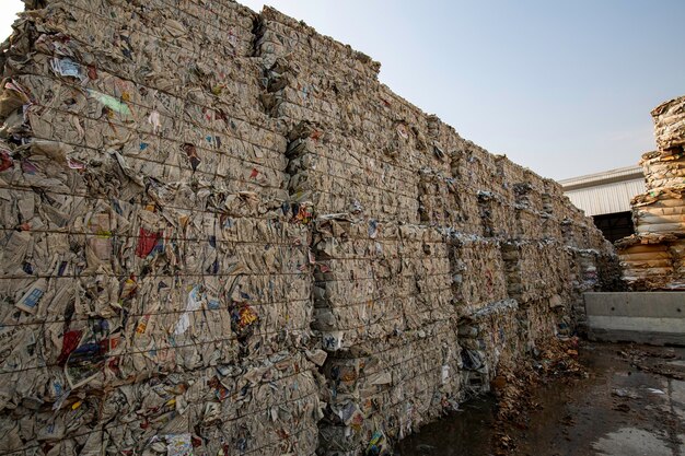 Papierstapel en stuk karton bij de papierfabriek van de recycle-industrie