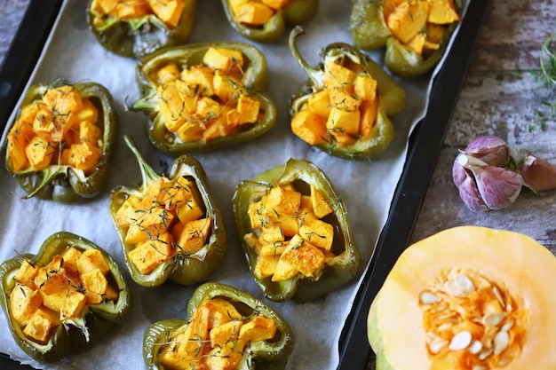 Paprika peppers stuffed with pumpkin. Baked paprika with pumpkin. Vegan lunch. Autumn food. Selective focus. 