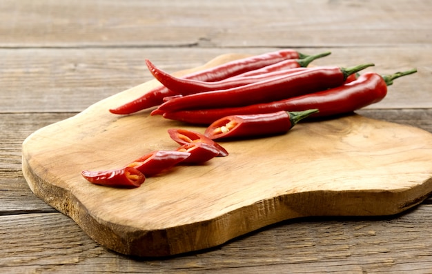 Paprika red hot chili pods on a wooden board.