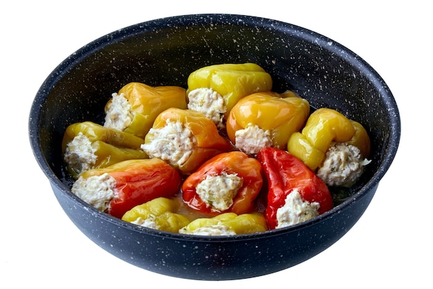 Paprika stuffed with minced meat in a frying pan isolated on white background