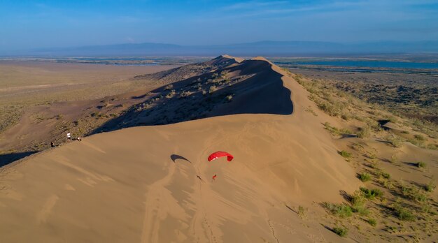 Paraglider on the background of sand dune top view