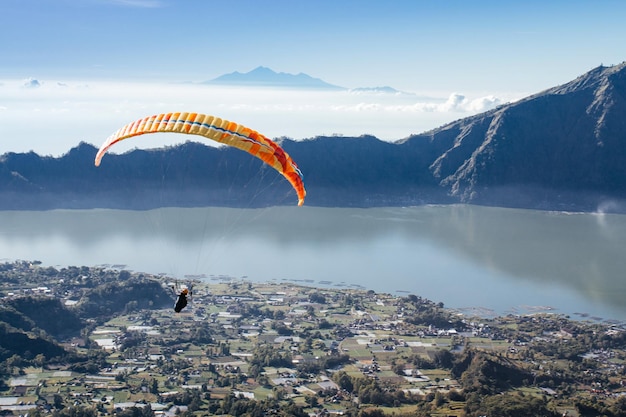 Paraglider in the blue sky The sportsman flying on a paraglider