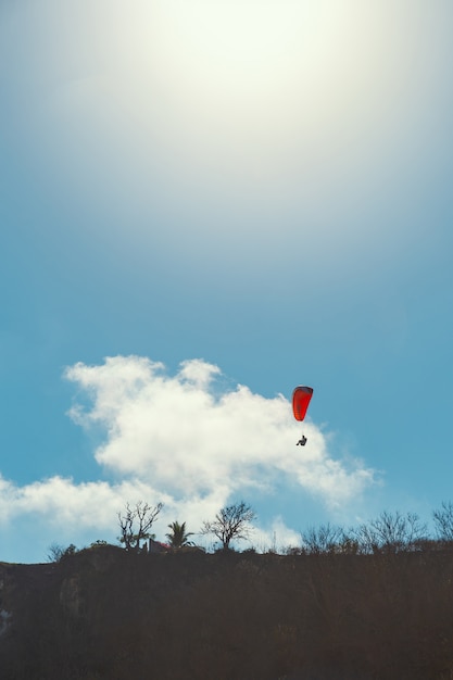 Paraglider and clear blue sky background