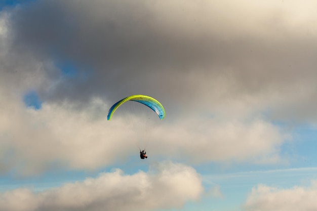 Paraglider vliegen over wolken in zomerdag