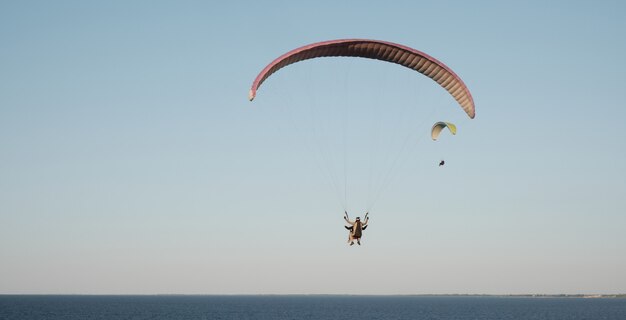 Paragliders against the blue sky