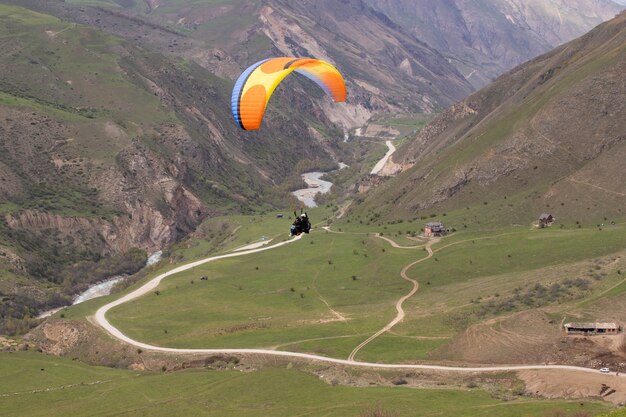 paragliders fly among the mountains