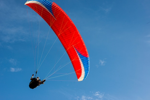 paragliding on the blue sky