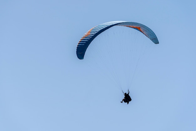 Paragliding flying on the hillside of Palomaret.