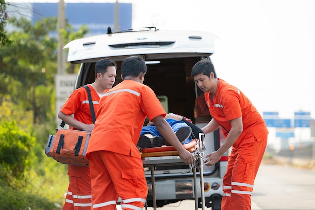 Photo the paramedic is assisting an injured man in an emergency situation on the road