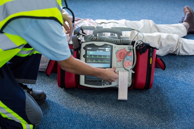 Photo paramedic using an external defibrillator during cardiopulmonary resuscitation