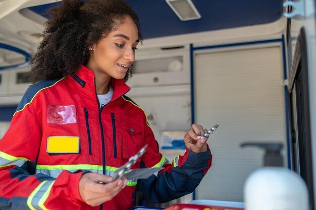 Paramedical professional monitoring pharmaceuticals in the ambulance car