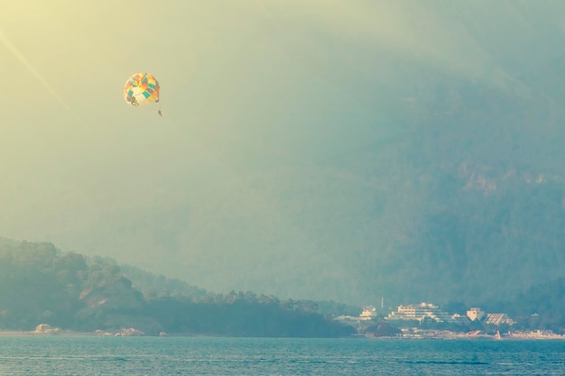 Parasailing over sea on a background of mountains