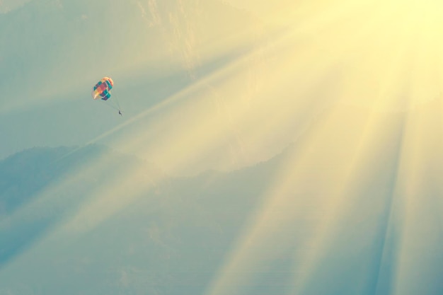 Parasailing over sea on a background of mountains