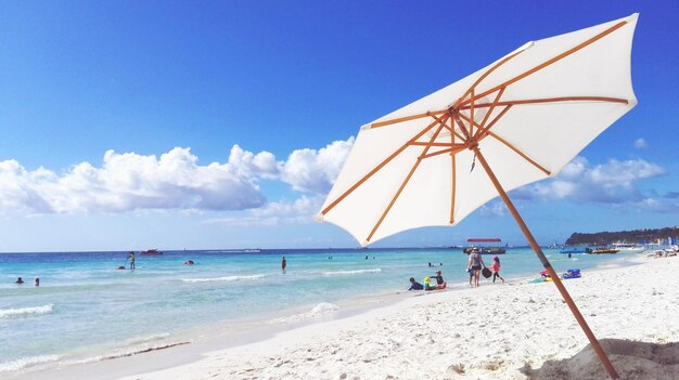 Parasol at beach against sky