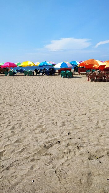 Parasols on beach against sky