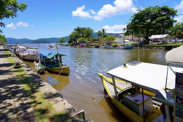 PARATY BRAZIL DECEMBER 25 2022 Embankment with traditional colorful boats of historical center of Paraty Rio de Janeiro Brazil