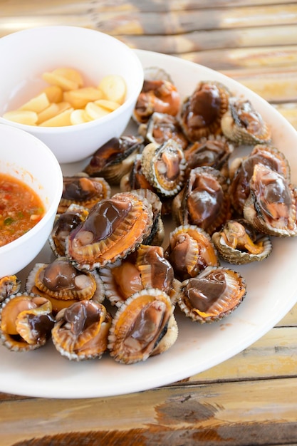 Parboiled cockles or bloody cockles with spicy Thai style dip sauce