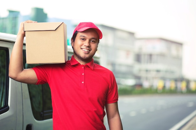 Parcel delivery man of a package through a service send to home. consign hand