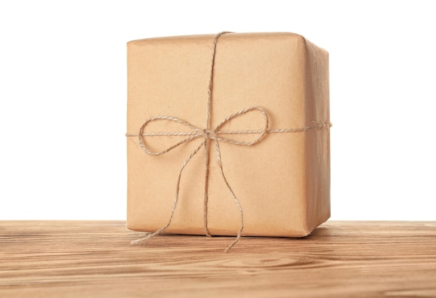 Parcel gift box on wooden table against white background