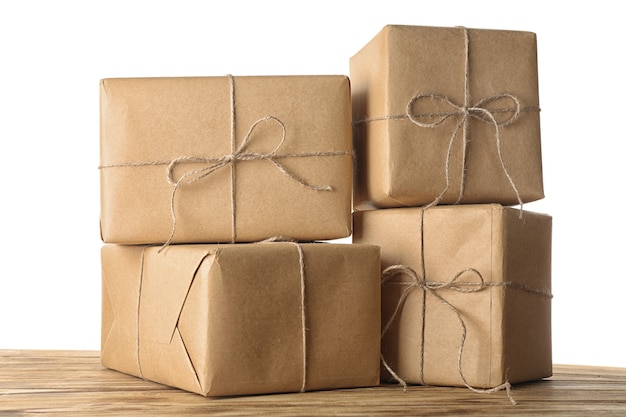 Parcel gift boxes on wooden table against white background