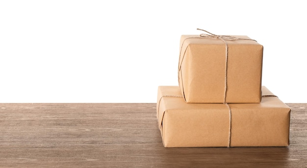 Photo parcel gift boxes on wooden table against white background