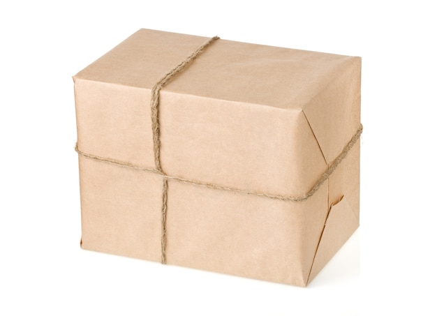 Parcel wrapped with brown paper tied rope isolated on white