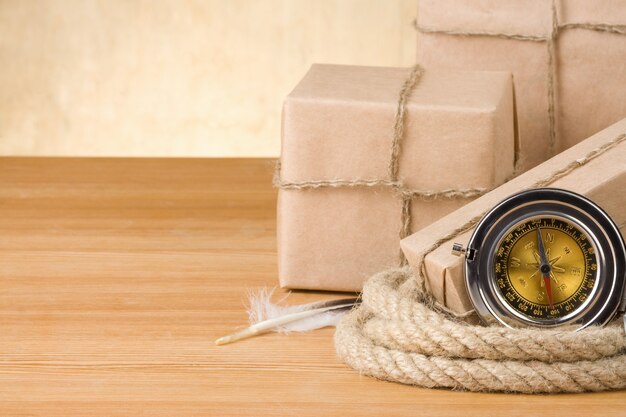 Parcel wrapped with brown paper tied with rope on wood background