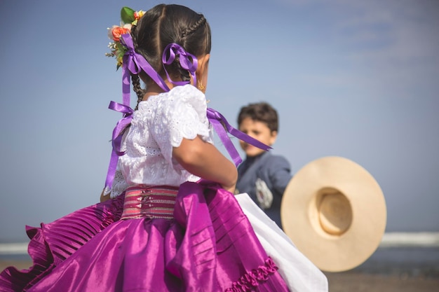 Pareja de jovenes bailarines bailando marinera peruana danza tradicional Peru