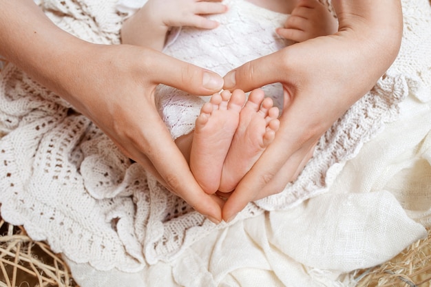 Parent holding feet of newborn baby in the hands