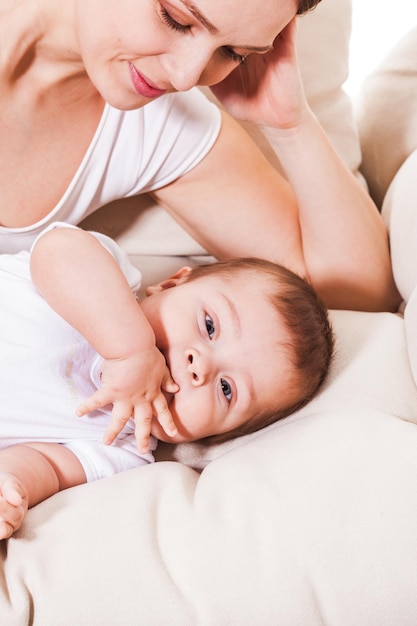 Parent and little kid lay at the bed at bedroom