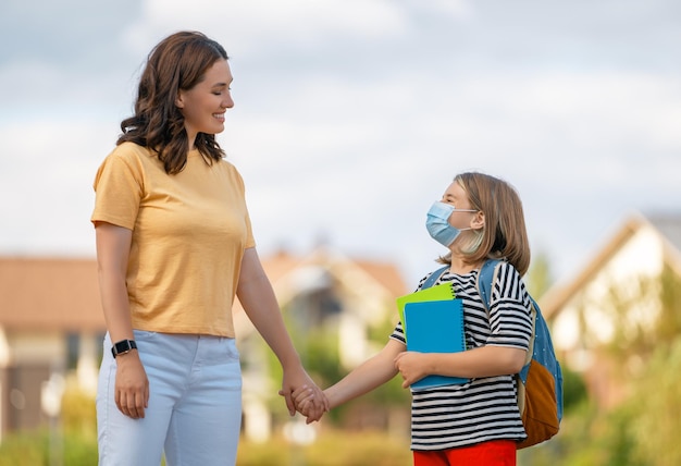 Parent and pupils going to school