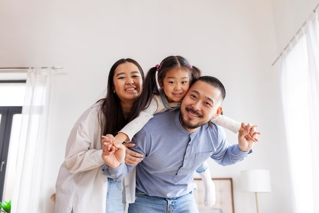 parental love and care asian happy family with little daughter rejoice at home little korean girl