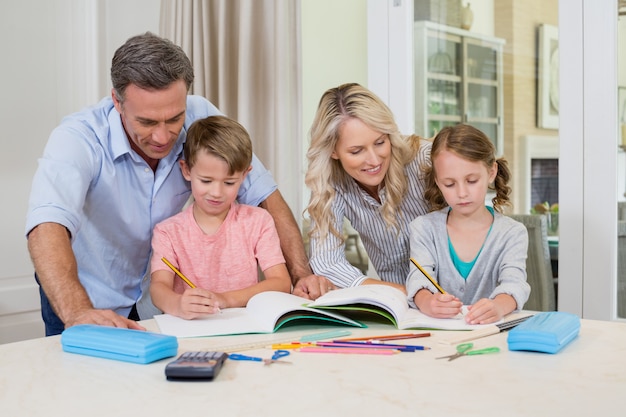 宿題をしている子供たちを助ける親